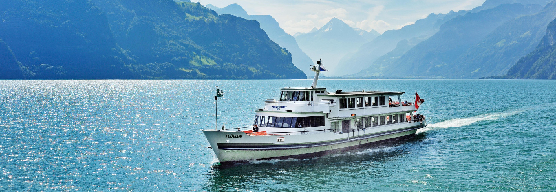 The motor vessel Flüelen sails from Uri to Lucerne on a beautiful summer day.
