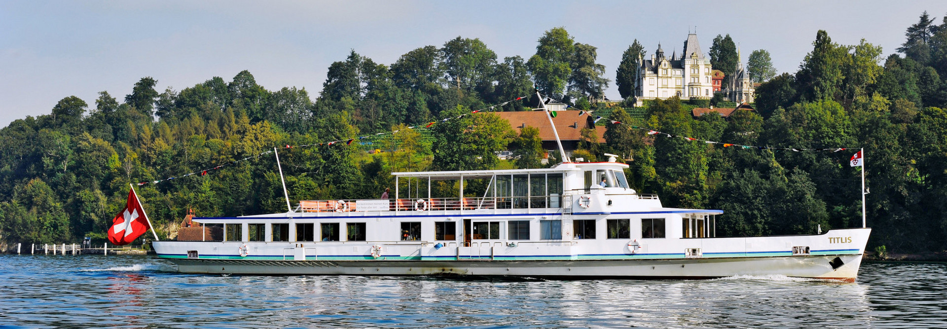 The motor vessel Titlis sails on Lake Lucerne in fine weather.