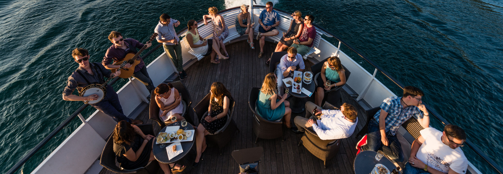 Open-air company aperitif on Lake Lucerne at summer.